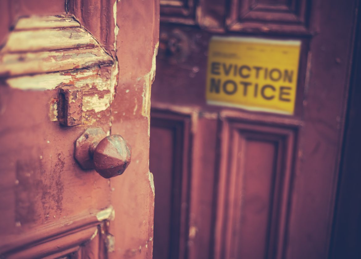 old wooden door with eviction notice
