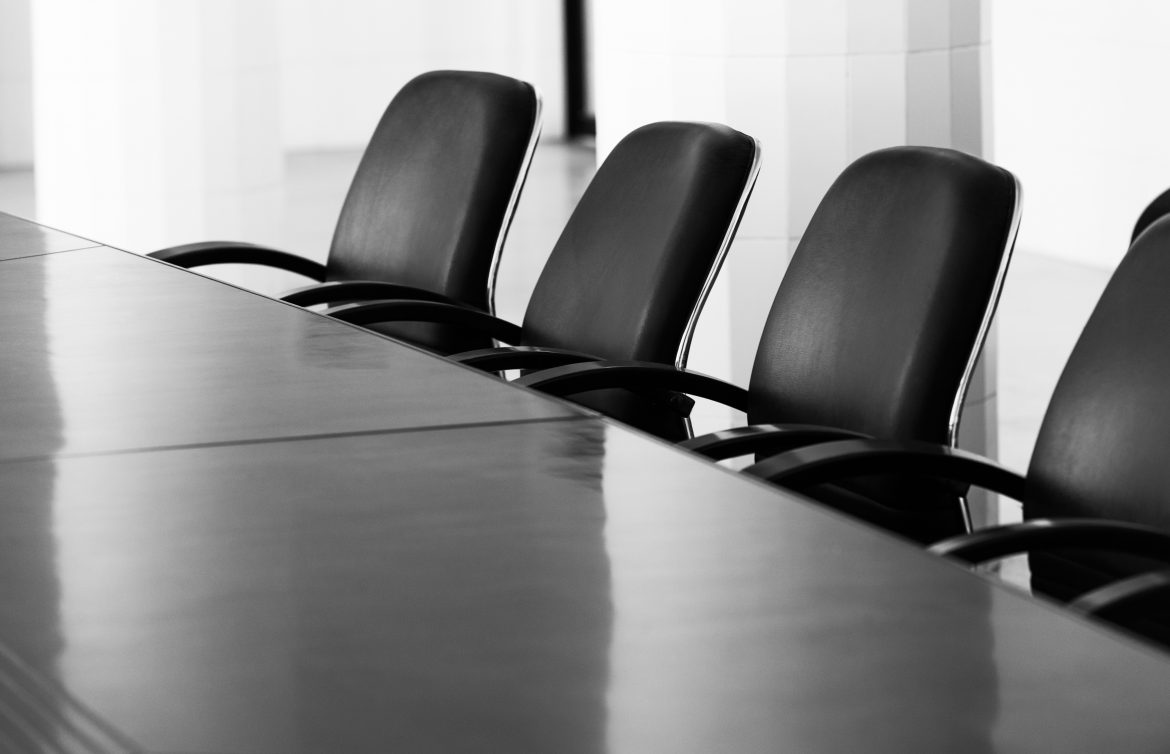 four black chairs in boardroom